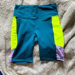 Fabletics teal and highlighter yellow high waisted bike shorts with mesh detail
